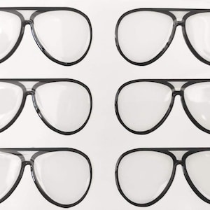 May include: Six pairs of aviator-style sunglasses with black frames and clear lenses are arranged on a white background. The sunglasses have a classic teardrop shape and a double bridge.