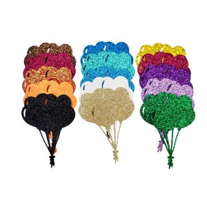 Könnte beinhalten: Satz mit zehn Glitzer-Ballon-Ausschnitten in verschiedenen Farben, darunter Rot, Orange, Gelb, Grün, Blau, Lila und Schwarz. Jeder Ballonausschnitt ist übereinander gelegt, um einen 3D-Effekt zu erzeugen.