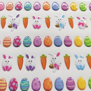 May include: A sheet of colorful Easter stickers featuring bunnies, carrots, and eggs. The stickers are 3D and have a glossy finish.