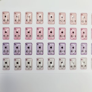 May include: A sheet of 40 phone case stickers with a cute cartoon design. The stickers are in various shades of pink, purple, and white. Each sticker features a cartoon phone with a smiling face, closed eyes, and a small apple logo.
