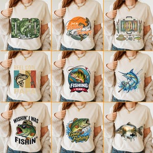 May include: A collection of beige t-shirts with fishing-themed graphics. Designs include fish, fishing rods, and text like "Dad", "Fishing Therapy", "Reel Cool Papa", and "Gone Fishing". The shirts are displayed on a person.