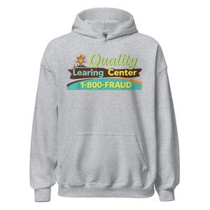 May include: A light gray hooded sweatshirt with a front pocket. The sweatshirt features the text "Quality Learning Center" in green, yellow, and brown, with the phone number "1-800-FRAUD" below.