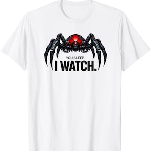 May include: White t-shirt featuring a stylized robotic spider design with a red head and black legs. The text "YOU SLEEP. I WATCH." is printed below the spider in bold, black letters. The shirt is a casual wear item.
