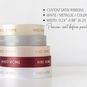 May include: A stack of custom satin ribbons in various colors, including cream, silver, blush, burgundy, and white. Each ribbon is printed with "HIKO HOME" in gold lettering. The ribbon width is 0.24"-0.98" (6-25 mm).