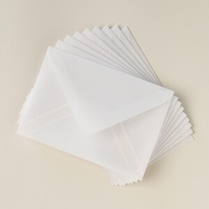 May include: A stack of white envelopes with a slightly textured surface.