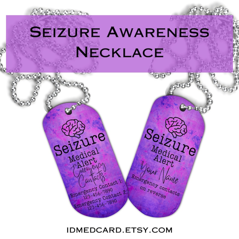 May include: A silver chain necklace with two purple and pink dog tags. The dog tags have a brain graphic and the text "Seizure Medical Alert" on them. One tag has the text "Emergency Contacts" and phone numbers. The other tag has the text "Your Name" and the text "Emergency contacts on reverse".