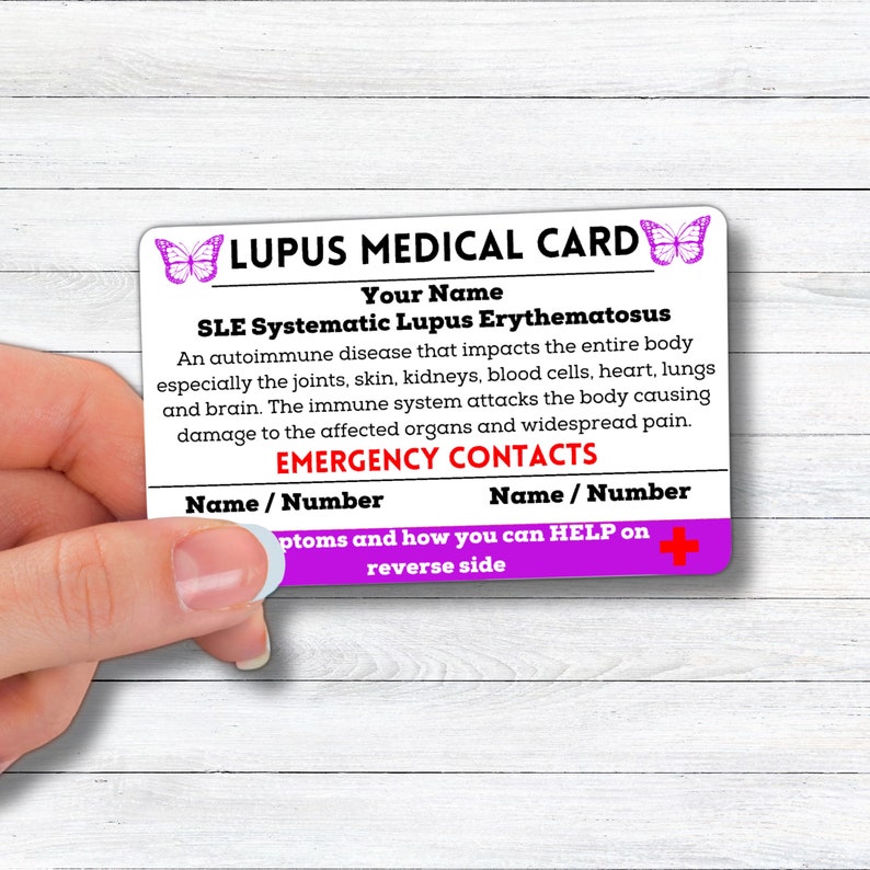 May include: A purple and white medical card with butterflies on the top and bottom. The card reads "Lupus Medical Card" and "SLE Systematic Lupus Erythematosus". The card also includes information about the autoimmune disease and has a section for emergency contacts.
