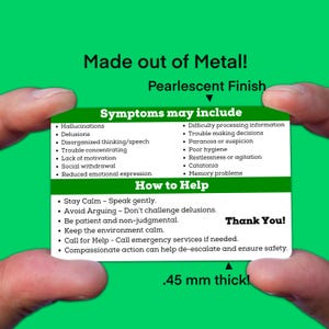 May include: A green card with the text "Made out of Metal! Pearlescent Finish" at the top. The card lists symptoms and how to help someone experiencing mental health challenges. The card is being held by a hand. The text "Thank You!" is at the bottom right corner of the card. The text ".45 mm thick!" is at the bottom center of the card.