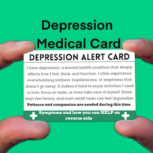 May include: A white card with the text "DEPRESSION ALERT CARD" in black. The card contains information about depression, a mental health condition, and encourages patience and compassion. The card also includes a plus sign and the text "Symptoms and how you can HELP on reverse side".