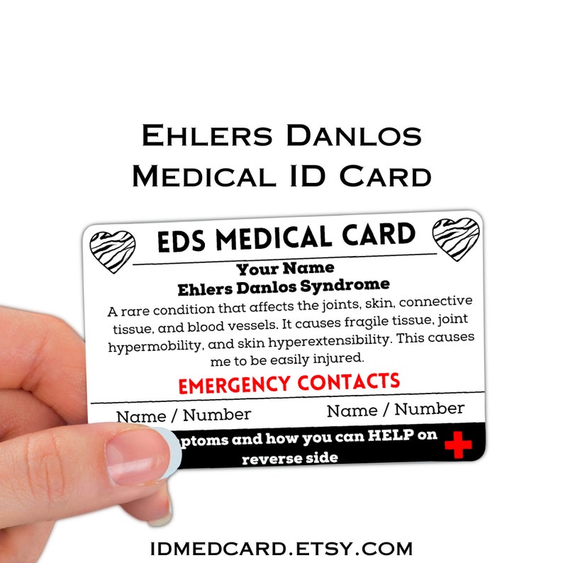 May include: A white medical ID card with a red heart and black stripes. The card reads "EDS Medical Card" and "Ehlers Danlos Syndrome". The card also includes information about the condition and emergency contacts.