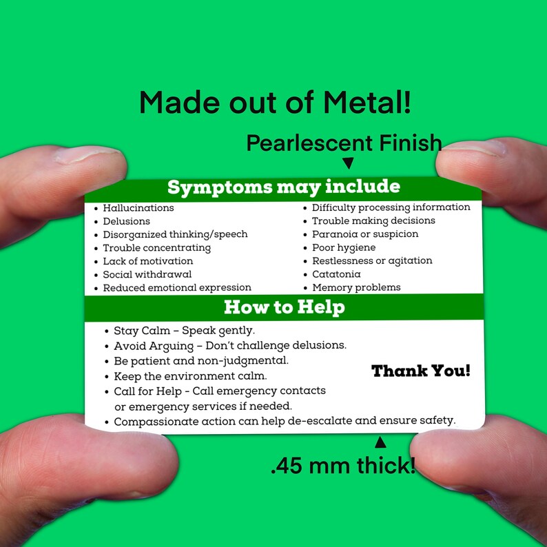 May include: A white card with blue and green text lists symptoms and how to help someone experiencing a mental health crisis. The card is made of metal and is 0.45 mm thick. The text on the card reads "Made out of Metal! Pearlescent Finish" and "Thank You!"