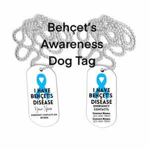 May include: Two white dog tags with silver ball chains. Each tag has a blue ribbon graphic and the text "I HAVE BEHÇET'S DISEASE". One tag has a space for a name, the other has emergency contact information.