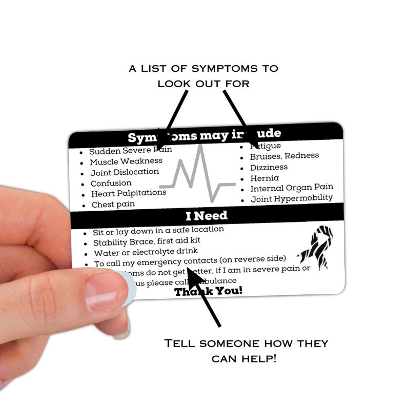 May include: A black and white card with a heart rate monitor graphic and the text "Symptoms may include" and "I Need". The card lists symptoms of a medical emergency and instructions for what to do if someone is experiencing these symptoms. The card also includes a zebra stripe pattern.