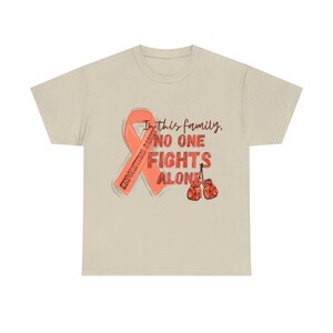 May include: A beige t-shirt featuring a pink ribbon and the text "In this family, no one fights alone". The ribbon has the words "Endometrial Cancer" written on it. Two red boxing gloves are depicted below the text.