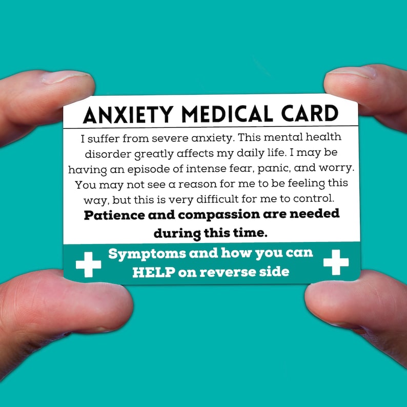 May include: A white card with blue text that reads "ANXIETY MEDICAL CARD". The card explains that the person has anxiety and may be having an episode of intense fear, panic, and worry. It also states that patience and compassion are needed during this time. The card has a blue plus sign on each side with the text "Symptoms and how you can HELP on reverse side".