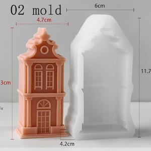 May include: A peach-colored house-shaped object next to a translucent white silicone mold. The object measures 10.3 cm in height, 4.7 cm in width, and weighs 95g. The mold measures 11.7 cm in height, 6 cm in width, and 4.2 cm in depth. Text reads 02 mold.