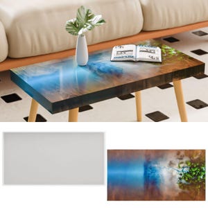 May include: A wooden coffee table with a blue and brown epoxy resin top. The table has a natural wood finish and is decorated with a book and a plant.
