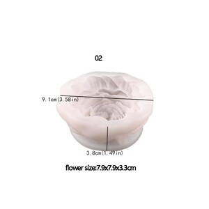 May include: A white silicone mold in the shape of a flower. The mold is 3.58 inches wide and 1.49 inches tall. The flower size is 3.11 x 3.11 x 1.3 inches. The number "02" is printed above the mold.