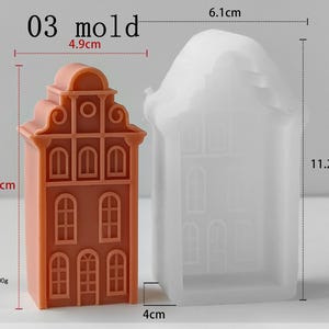May include: A terracotta-colored house-shaped object and a translucent white silicone mold of the same design. The terracotta piece is 9.8 cm tall and 4.9 cm wide, weighing 100g. The mold measures 11.2 cm in height, 6.1 cm in width, and 4 cm in depth.