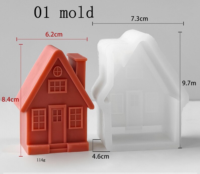 May include: A terracotta-colored house-shaped object next to a translucent white silicone mold. The house measures 6.2 cm wide by 8.4 cm high and weighs 114g. The mold measures 7.3 cm wide by 9.7 cm high and 4.6 cm deep. Text reads 01 mold.