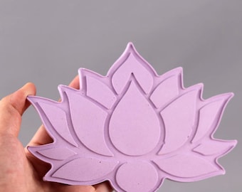 May include: A light purple lotus flower shaped silicone mold. The mold has a detailed design with raised edges.