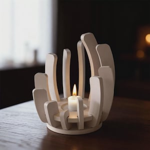 May include: A white wooden candle holder with a lit white candle. The holder has a circular base and curved, vertical supports. The candle flame is bright against the dark background. The candle holder is a decorative home accent.