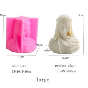 May include: A pink silicone mold and a finished cream-colored sculpture of a veiled bust. The mold measures 15cm x 10.5cm x 16cm. The sculpture is 13.5cm x 9.5cm x 15cm. The word "large" is below the objects.