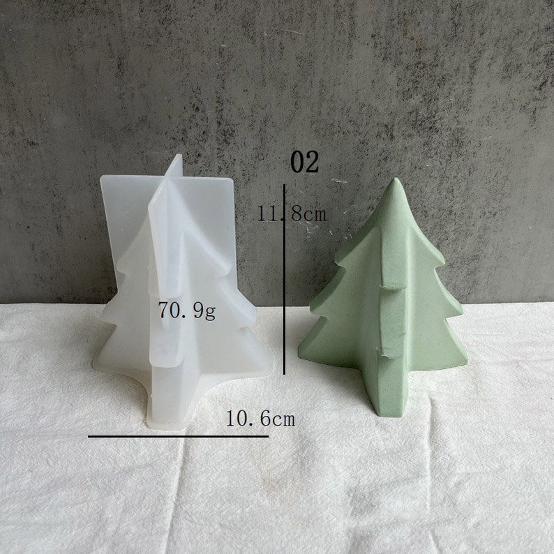 May include: A white silicone Christmas tree mold with the text "70.9g" and measurements of 10.6 inches and 11.8 inches. Next to the mold is a green Christmas tree made of concrete, measuring 11.8 inches tall.