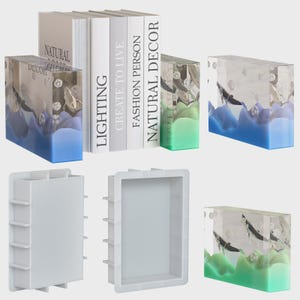 May include: Decorative bookends and molds. The bookends have a clear resin design with blue and green wave patterns. The books have white covers with titles such as "LIGHTING" and "NATURAL DECOR".