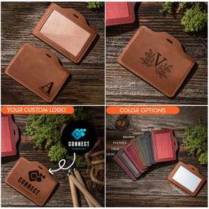 May include: A brown leather badge holder with a clear plastic window for displaying an ID card. The holder has a metal clip for attaching to a belt or lanyard. The holder can be personalized with a monogram or logo. The image shows a variety of color options for the holder.