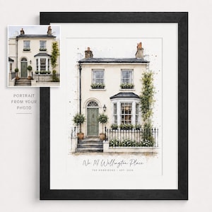 May include: A framed watercolour illustration of a two-storey cream-coloured house with a green front door, a bay window, and climbing ivy. The text below the house reads No. 14 Wellington Place, THE HARRISONS, EST. 2024, presented in a black frame.