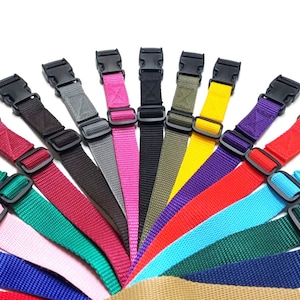 May include: Assortment of 12 colourful adjustable straps with black plastic buckles. The straps are made of woven nylon and come in a variety of colours, including red, blue, green, yellow, and purple.