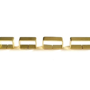 May include: Four gold-coloured metal rectangular rings of different sizes.