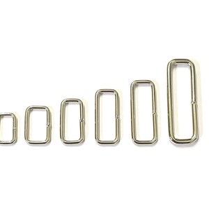 May include: A set of seven silver metal D-rings of varying sizes. The rings are arranged in order of size, with the smallest ring on the left and the largest ring on the right.