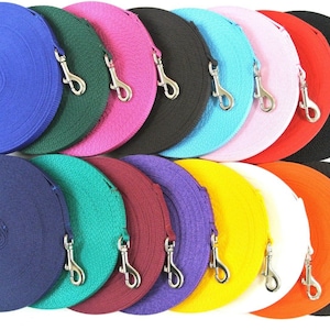 May include: A set of 15 dog leads in various colours, including blue, green, pink, black, white, and orange. Each lead has a silver clip.