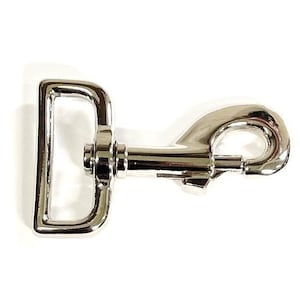 May include: A silver metal swivel hook with a D-ring. The hook is designed for attaching to a leash or other item.