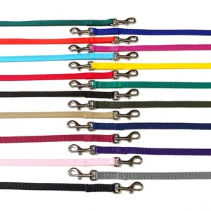 May include: Assortment of 15 dog leads in various colours, each with two silver swivel clips. The leads are made of a durable nylon material.