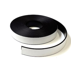 May include: A roll of black magnetic tape with adhesive backing. The tape is rolled up and a portion of the tape is unrolled, showing the adhesive side.
