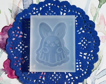 May include: A clear silicone mold for making resin crafts. The mold features a cute ghost bunny design with big eyes and a small mouth.
