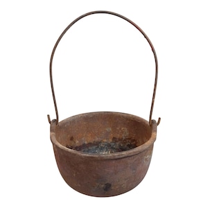 May include: A rusty cast iron pot with a wire handle. The pot is round and has a wide opening. It is a vintage kitchen item.