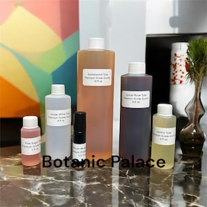 May include: Six glass bottles of essential oils with labels. The bottles are labeled with the type of oil, including Sandalwood, Somali Rose, Amber White, Pink Sugar, Vanilla, and African Musk. The bottles are arranged on a marble surface with the text "Botanic Palace" in the foreground.