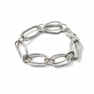 May include: A silver-toned bracelet constructed from a series of interconnected, elongated oval links. Each link features a textured, hammered surface finish, creating a reflective and irregular appearance throughout the entire chain-link design.