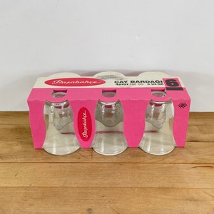 May include: A set of six clear glass tea cups in a pink cardboard retail package. The packaging features the brand name Paşabahçe, the text ÇAY BARDAĞI, the model number 42191, and the capacity 100 cc or 3 1/4 oz, with a large number 6 printed.
