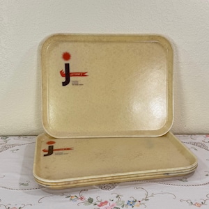 May include: A set of three rectangular beige serving trays with a speckled finish. Each tray features a black letter J logo, a red sun icon, and a red banner with the text JAYTON'S printed in black, along with smaller text below the banner.