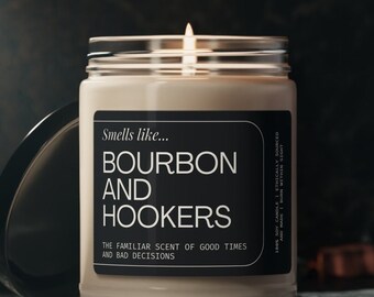 May include: A brown glass candle with a black label that reads "Smells like... BOURBON AND HOOKERS THE FAMILIAR SCENT OF GOOD TIMES AND BAD DECISIONS 100% SOY CANDLE ETHICALLY SOURCED AND MADE BURN WITHIN SIGHT".