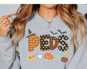 May include: A gray sweatshirt with a Halloween-themed design featuring the word "PEDS" in orange and black with various Halloween icons like a witch's hat, ghosts, pumpkins, and a cauldron.