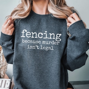 May include: A dark gray sweatshirt with the text "fencing because murder isn't legal" printed in white.