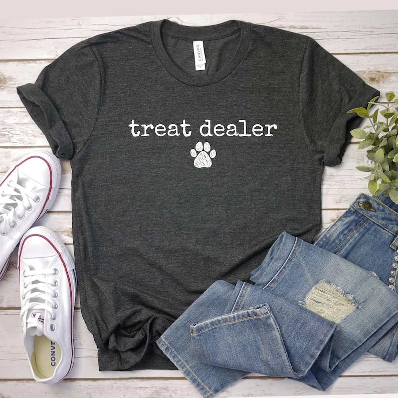 a t - shirt that says treat dealer with a paw on it