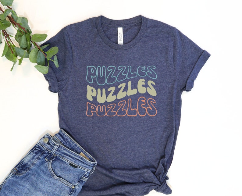 a t - shirt that says puzzles and a pair of jeans