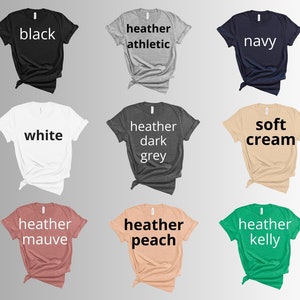 May include: Nine different color t-shirts, including black, white, heather athletic, heather dark grey, navy, soft cream, heather mauve, heather peach, and heather kelly.
